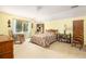 Cozy bedroom with a patterned comforter, wooden furniture, and a view to the outside at 1218 Chersonese Round, Mount Pleasant, SC 29464