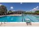 Large community pool with clear blue water, lounge chairs, and umbrellas for relaxing at 1218 Chersonese Round, Mount Pleasant, SC 29464