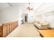 Bright and airy loft area with a neutral color palette, ceiling fan, and comfortable seating arrangement at 1218 Chersonese Round, Mount Pleasant, SC 29464