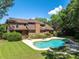 Expansive backyard with a sparkling pool surrounded by lush landscaping on a sunny day at 1218 Chersonese Round, Mount Pleasant, SC 29464