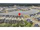 An aerial view of a residential neighborhood with a lake and a red pin marking a property location at 1273 Locals St, Summerville, SC 29485