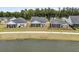 Three homes with screened in porches line a sidewalk with a pond behind them at 1273 Locals St, Summerville, SC 29485