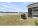 Lush backyard with an outdoor grill and views of the tranquil lake community at 1273 Locals St, Summerville, SC 29485