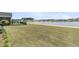Lawn with lake view beyond wrought iron fence, and an adjacent path at 1273 Locals St, Summerville, SC 29485