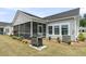 Backyard with an outdoor grill on the patio and a screened-in porch, perfect for outdoor gatherings at 1273 Locals St, Summerville, SC 29485