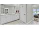 Bathroom with double vanity, marble countertops, large mirror, and view to Primary bedroom at 1273 Locals St, Summerville, SC 29485