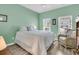 Bedroom features a large bed, two windows, a wicker chair, and light green walls at 1273 Locals St, Summerville, SC 29485