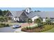 Elegant clubhouse featuring a porte cochere, manicured landscaping, and a welcoming entrance at 1273 Locals St, Summerville, SC 29485