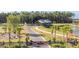 Inviting community entrance with a covered bridge, fountains, and palm trees near a serene lake at 1273 Locals St, Summerville, SC 29485