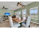 Inviting dining area with a wood table, stylish chairs, modern light fixture, and beautiful water views at 1273 Locals St, Summerville, SC 29485