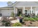 Charming home featuring a landscaped front yard, inviting porch, and attached garage at 1273 Locals St, Summerville, SC 29485
