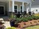 Charming front porch with rocking chairs and beautiful landscaping welcomes you home at 1273 Locals St, Summerville, SC 29485
