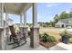 Relax on the rocking chairs featured on this welcoming front porch, with verdant landscaping at 1273 Locals St, Summerville, SC 29485