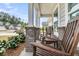 Relax on this home's covered front porch with classic rocking chairs and brick-based columns at 1273 Locals St, Summerville, SC 29485
