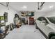 Spacious garage with ample storage space, featuring overhead racks and a white car parked inside at 1273 Locals St, Summerville, SC 29485