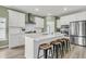 Modern kitchen featuring an island with a breakfast bar, stainless appliances, and white cabinets at 1273 Locals St, Summerville, SC 29485