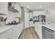 Modern kitchen with white cabinets, stainless steel appliances, and a gas cooktop at 1273 Locals St, Summerville, SC 29485