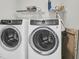 Modern laundry room features front loading washer and dryer with a shelf above for storage at 1273 Locals St, Summerville, SC 29485