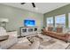 Comfortable living room features a brown sofa, a flatscreen TV, and plush furnishings at 1273 Locals St, Summerville, SC 29485
