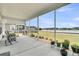 Relaxing screened-in porch with a view of the serene lake and manicured landscaping at 1273 Locals St, Summerville, SC 29485