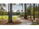 Peaceful walking path winding through mature trees and overlooking a tranquil pond at 1273 Locals St, Summerville, SC 29485