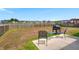 A view of the backyard of the home, showing the concrete patio, grill, and seating area at 130 Stagecoach Ave, Summerville, SC 29486