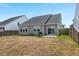 A view of the backyard of the home, showing the home's exterior siding and patio at 130 Stagecoach Ave, Summerville, SC 29486