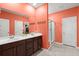Bright bathroom with dual sinks, dark wood cabinets, and a glass-enclosed shower at 130 Stagecoach Ave, Summerville, SC 29486