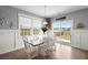 Bright dining room with modern decor, large windows, and sliding glass door to the backyard at 130 Stagecoach Ave, Summerville, SC 29486