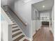Hallway featuring stairs with wood and white trim, leading to additional living spaces at 130 Stagecoach Ave, Summerville, SC 29486