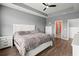 Spacious main bedroom featuring a tray ceiling, ceiling fan, and gray walls with wood-look flooring at 130 Stagecoach Ave, Summerville, SC 29486