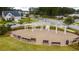 Outdoor gathering space with a beautiful pergola, benches, and hardscape perfect for community events at 130 Stagecoach Ave, Summerville, SC 29486