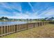 Community pond behind the property with a wooden fence in the foreground at 130 Stagecoach Ave, Summerville, SC 29486