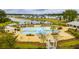 Community pool with beach entry, pergolas, palm trees, and lake views at 130 Stagecoach Ave, Summerville, SC 29486