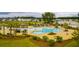 Aerial view of the neighborhood pool with palm trees, lounge chairs, and seating areas at 130 Stagecoach Ave, Summerville, SC 29486