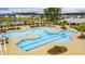 Aerial view of neighborhood pool, including a splashpad, trees, and lounge areas at 130 Stagecoach Ave, Summerville, SC 29486