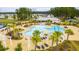 Community pool with zero entry, palm trees, and a splash pad feature at 130 Stagecoach Ave, Summerville, SC 29486