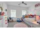Bright bedroom with lots of windows and a playful arrangement of toys and stuffed animals at 1348 Seaside Plantation Dr, Charleston, SC 29412