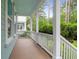 Inviting covered porch with white railing and ample space for outdoor seating or relaxing with nature at 1348 Seaside Plantation Dr, Charleston, SC 29412