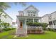Charming two-story home with a covered porch and orange front door, enhancing its curb appeal at 1348 Seaside Plantation Dr, Charleston, SC 29412