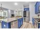 Open kitchen with stainless steel appliances, blue cabinets and an island overlooking the living area at 1348 Seaside Plantation Dr, Charleston, SC 29412