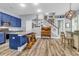 Bright kitchen featuring a blue island with granite countertops and unique wooden bar stools at 1348 Seaside Plantation Dr, Charleston, SC 29412