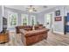 Elegant living room with large windows, comfortable seating, and hardwood floors, creating a relaxing space at 1348 Seaside Plantation Dr, Charleston, SC 29412