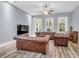 Cozy living room featuring hardwood floors, plentiful natural light, and comfortable leather seating arrangement at 1348 Seaside Plantation Dr, Charleston, SC 29412