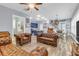 Spacious living room featuring hardwood floors, leather sofas, and an open flow to the kitchen at 1348 Seaside Plantation Dr, Charleston, SC 29412