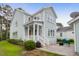 Charming two-story home with a lush, landscaped yard and a rear detached garage at 1348 Seaside Plantation Dr, Charleston, SC 29412
