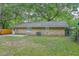 Spacious backyard featuring lush trees, a patio, and well-maintained lawn space at 141 Larson Dr, Summerville, SC 29485