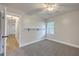 Cozy bedroom with neutral carpet, a ceiling fan, and a bright window with natural light exposure at 141 Larson Dr, Summerville, SC 29485