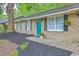 Charming brick home featuring a vibrant turquoise front door, a well-manicured yard, and a welcoming entrance at 141 Larson Dr, Summerville, SC 29485