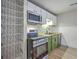 Efficient kitchen design with stainless steel appliances, subway tile backsplash, and green and white cabinets at 141 Larson Dr, Summerville, SC 29485